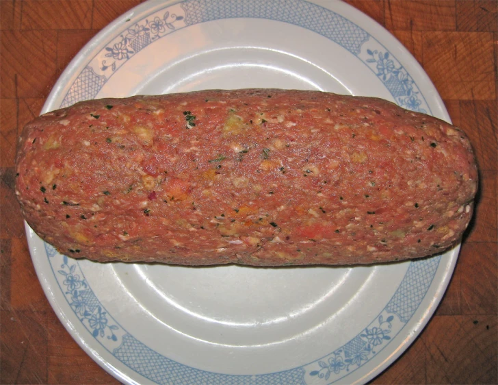 a very large sausage sitting on top of a white plate