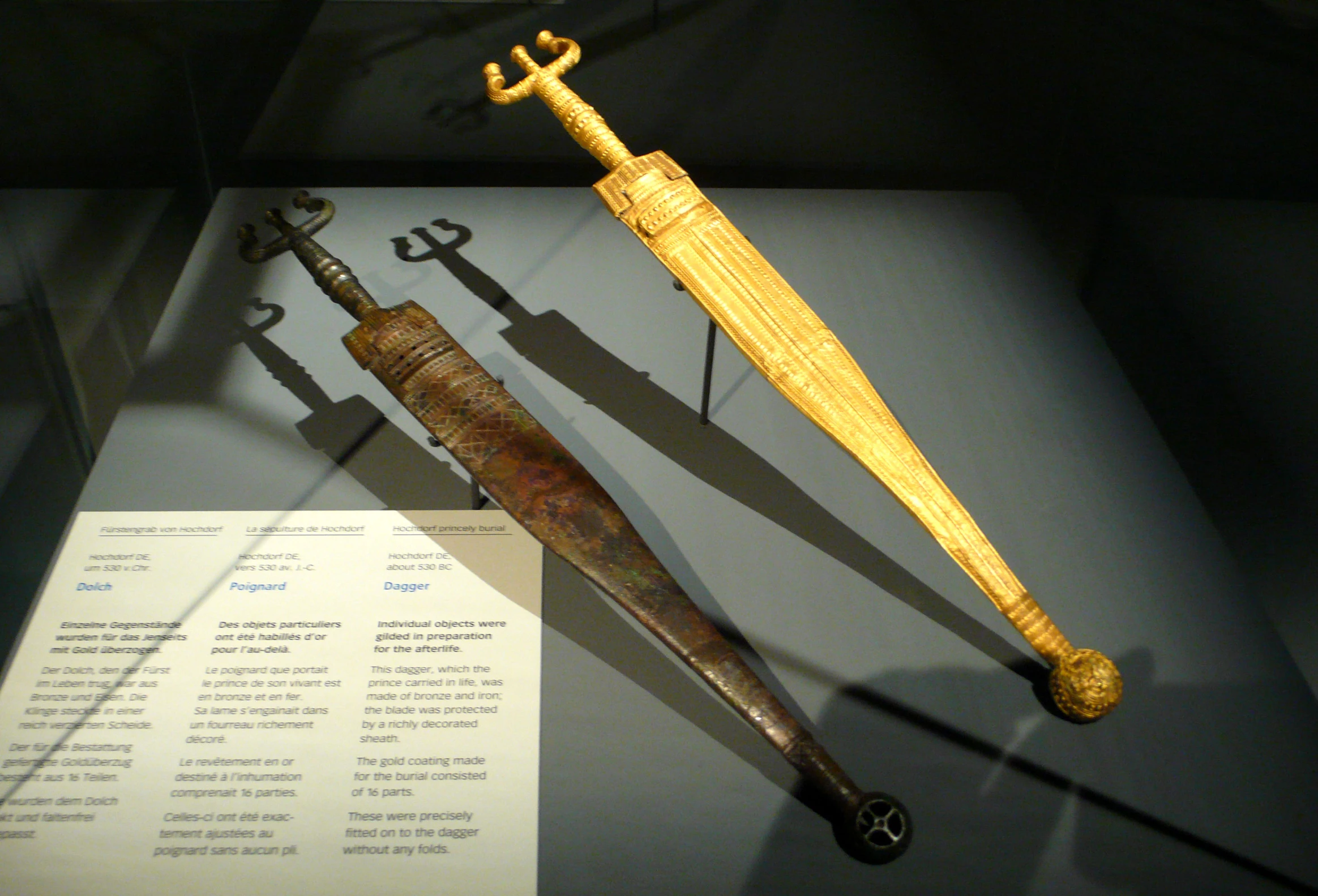 two swords on display in glass case