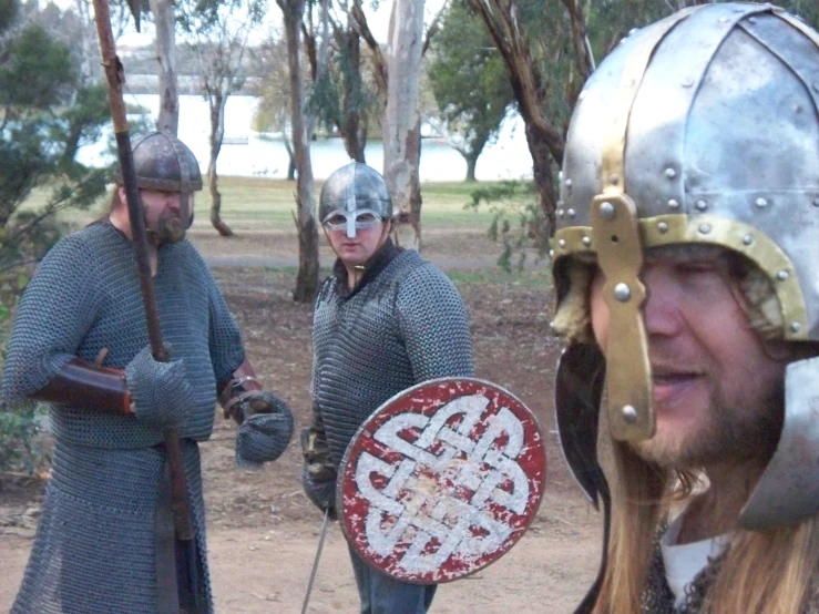 three men in armor and helmets standing together