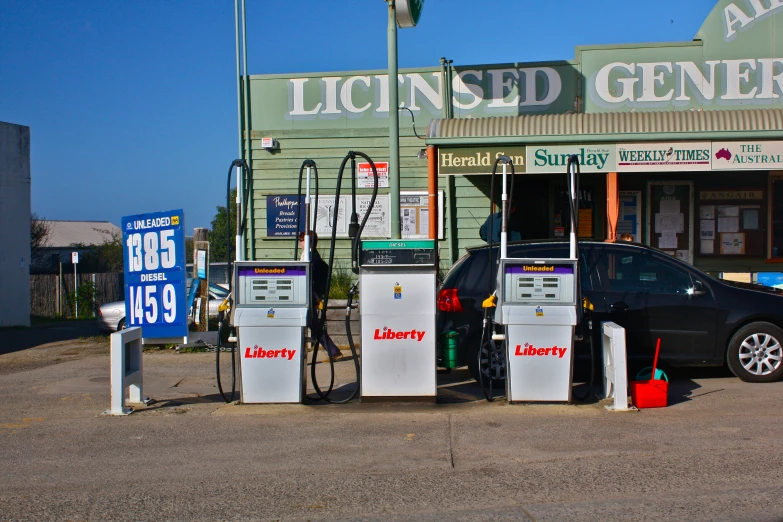 a car is parked at the pump near the signs