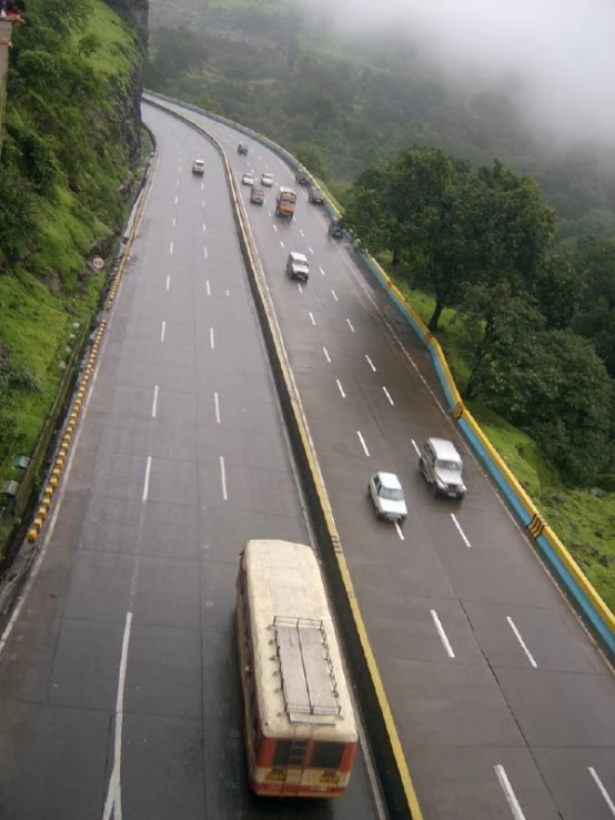 a view of a busy freeway with heavy rain hitting a city