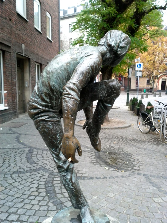 a statue of a man playing on his hand