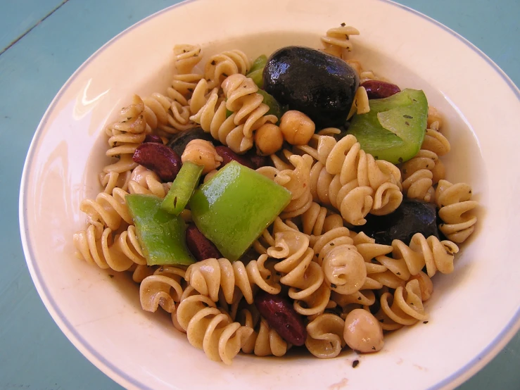 a white bowl filled with different types of pasta