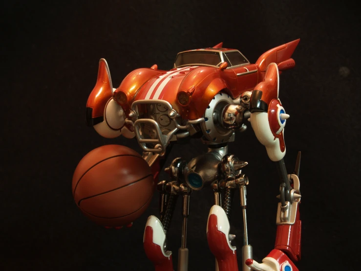 the robot is holding a basketball that is on its legs