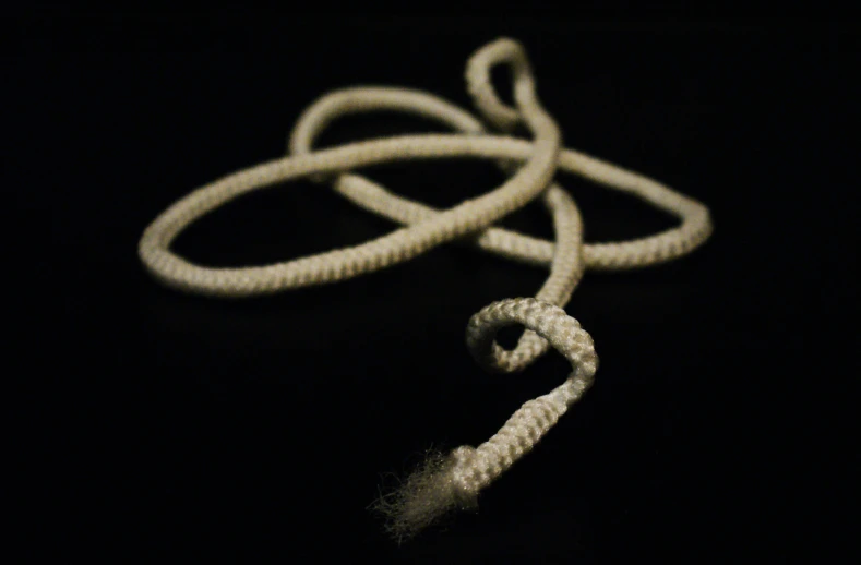 white rope attached to a black background