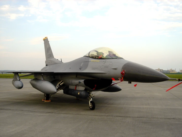 an air force jet sitting on top of an airport tarmac