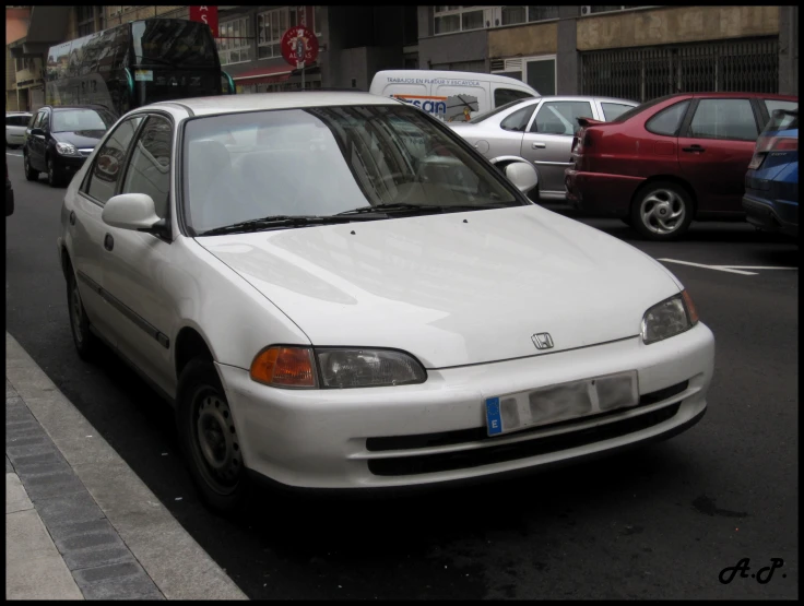 this is a po of a white car parked on the side of the street