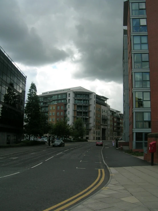an empty city street with a cloudy sky