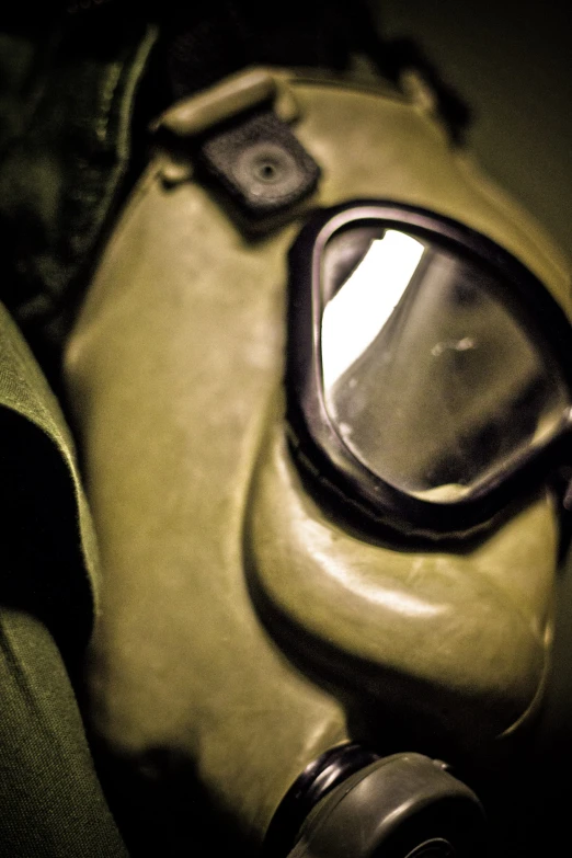 old gas mask and protective glasses with on on wall