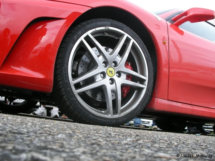 the wheel on the red car is seen from the side