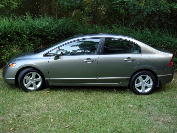 a gray and black car parked in the grass