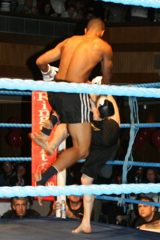 two men on the rings with their feet in the air