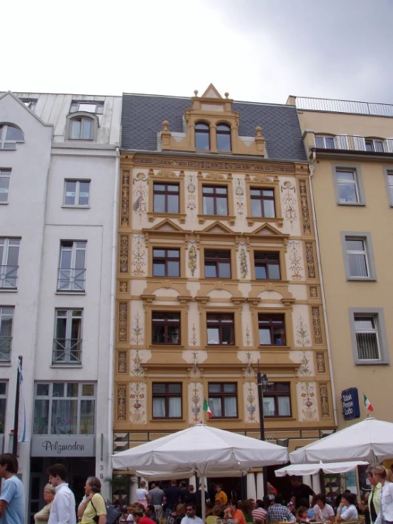 large building near street with many people in front