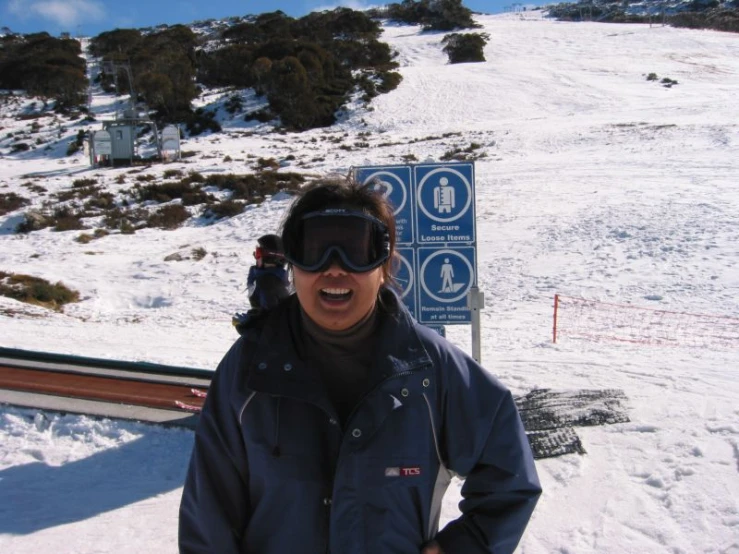 a woman smiles while standing in the snow