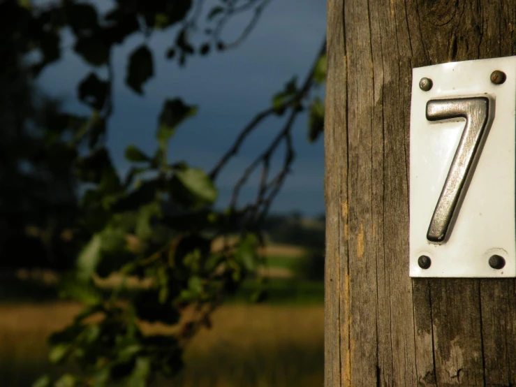 the number seven on the side of the wooden post
