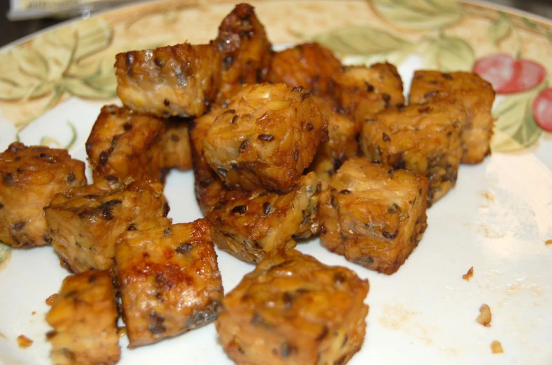 some chicken is sitting on a plate with toothpicks