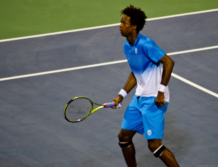 a man swinging a tennis racket on a court