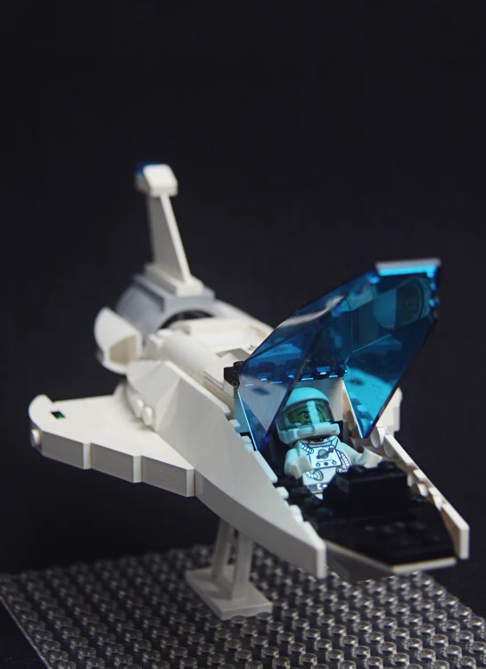 small model of a white space ship with blue and silver accents