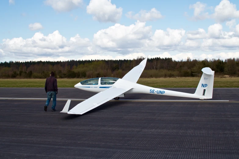 a person standing in front of a small plane