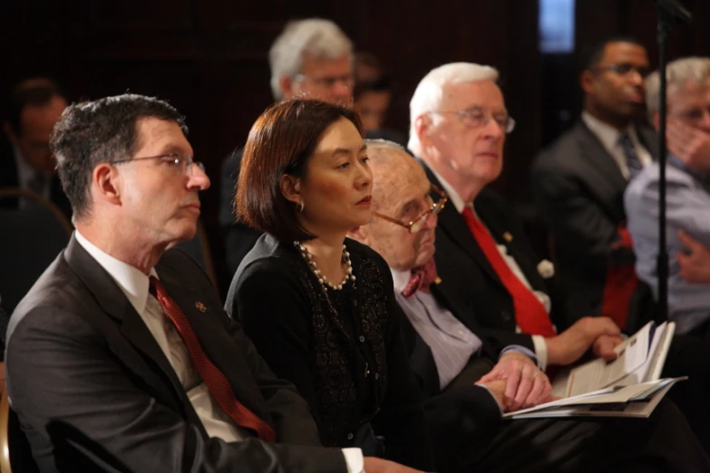 several business people sitting side by side in a room