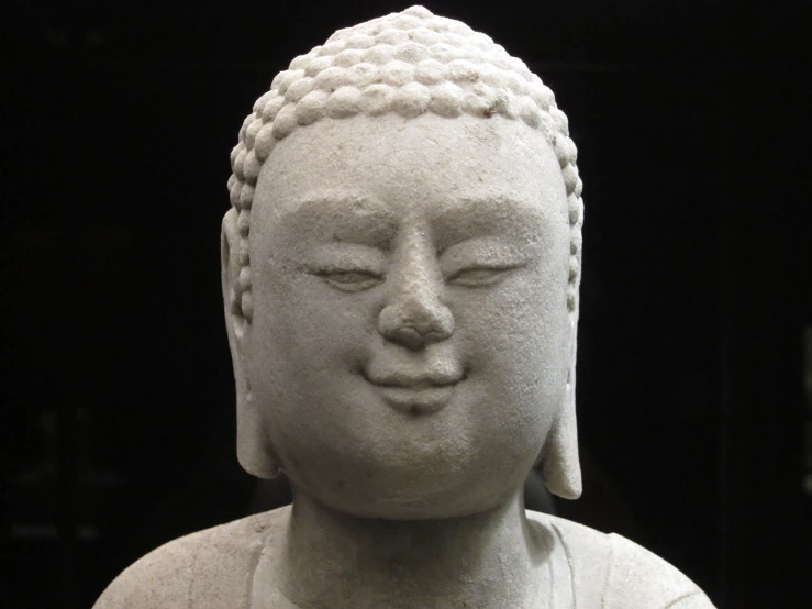 a white statue that is sitting down