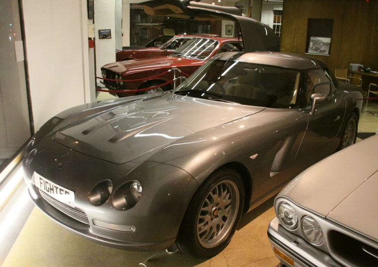 several cars are parked and in a show room