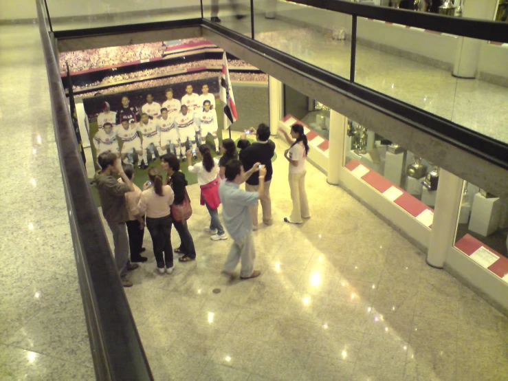 several people are standing in the middle of a mall