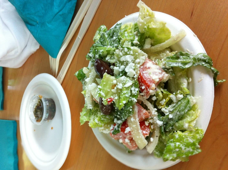 salad on plate with fork and other dishes in background