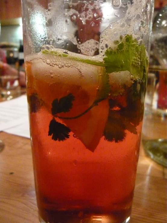 a glass full of drinks sitting on a table