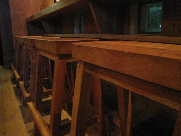 several chairs sitting on a wooden shelf in a room