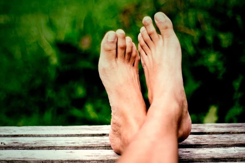 the toes and ankles of a person resting on a table