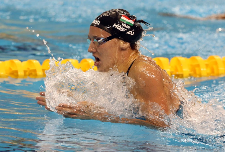 a female swimmer swimming in the pool during the olympics