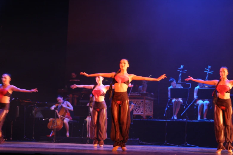 dancers are performing with each other on stage