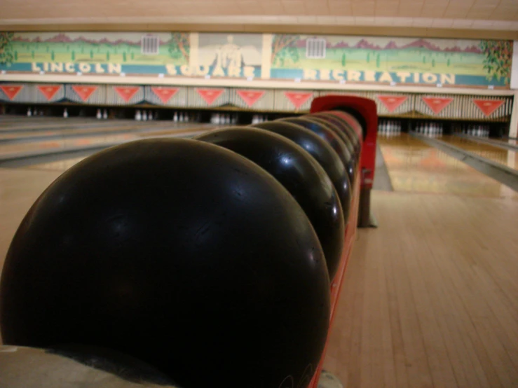 a row of bowling pins in an indoor bowling court