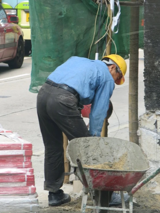 a man works with concrete on a street