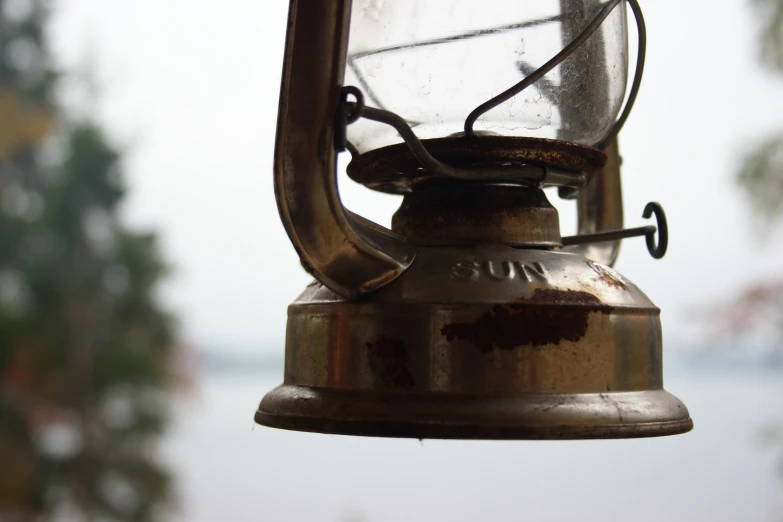 this is an image of a rusted lantern hanging