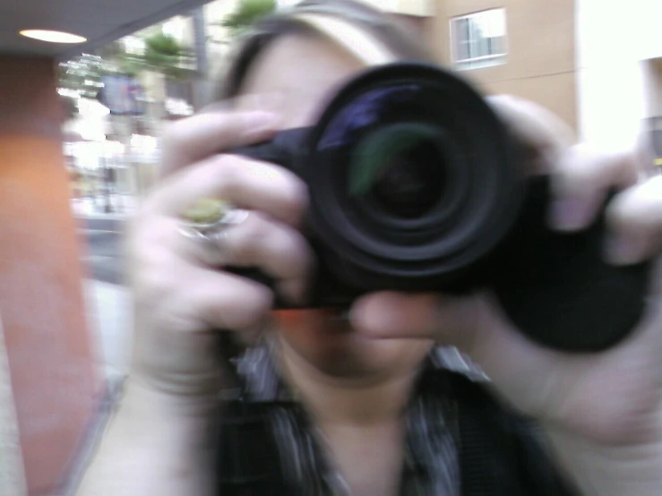 woman taking a picture with her digital camera
