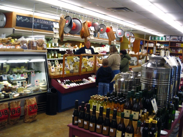 two people standing in a store near many shelves with food items