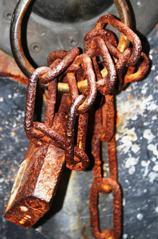 a piece of rusty chain hanging from a hook