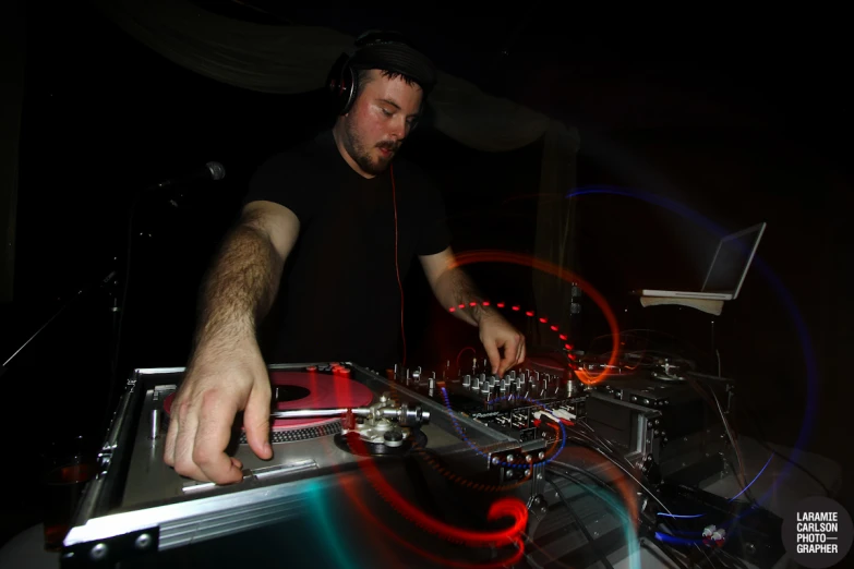 a man in headphones mixing a dj set