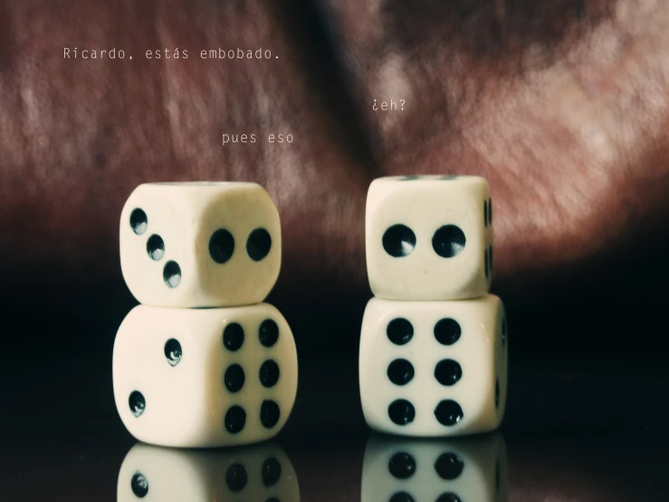 a set of three dice is sitting on top of each other