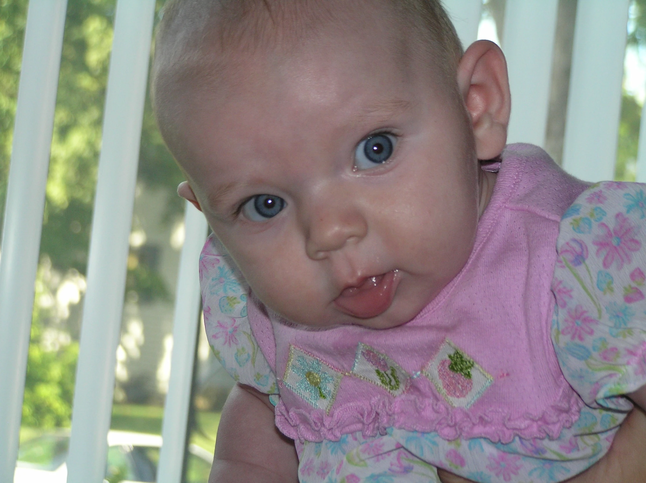 the baby in her mother's pink dress is being held