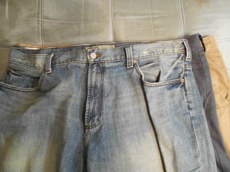 three jeans are seen from the waist up