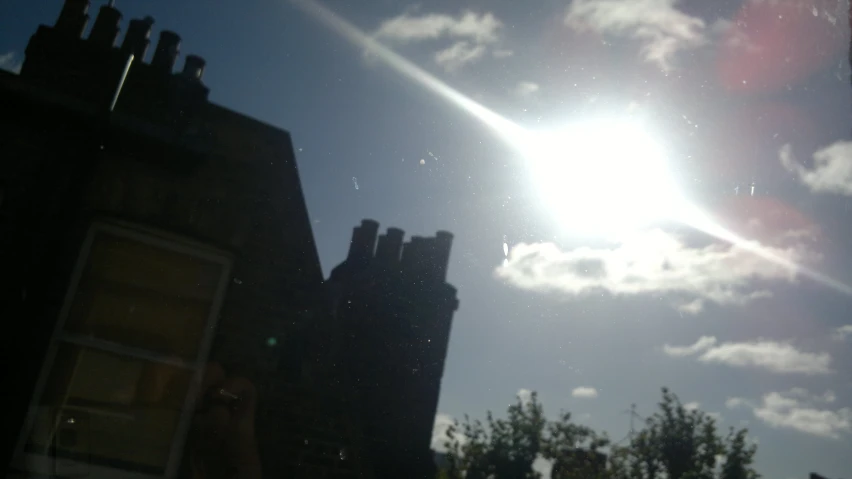 the sun shining brightly through some clouds in a clear sky