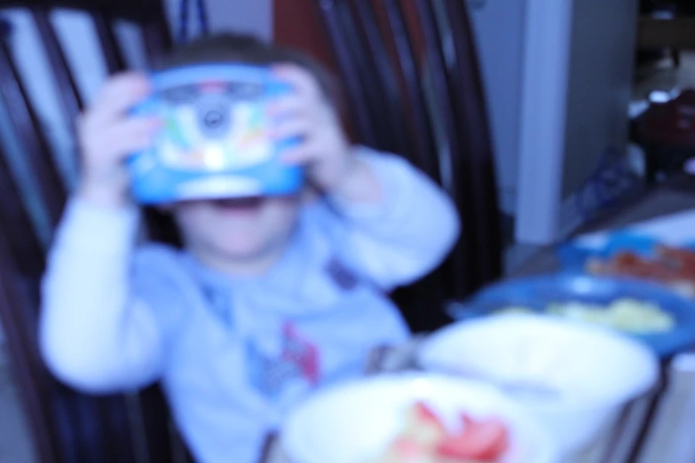 a boy looking through his glass for food