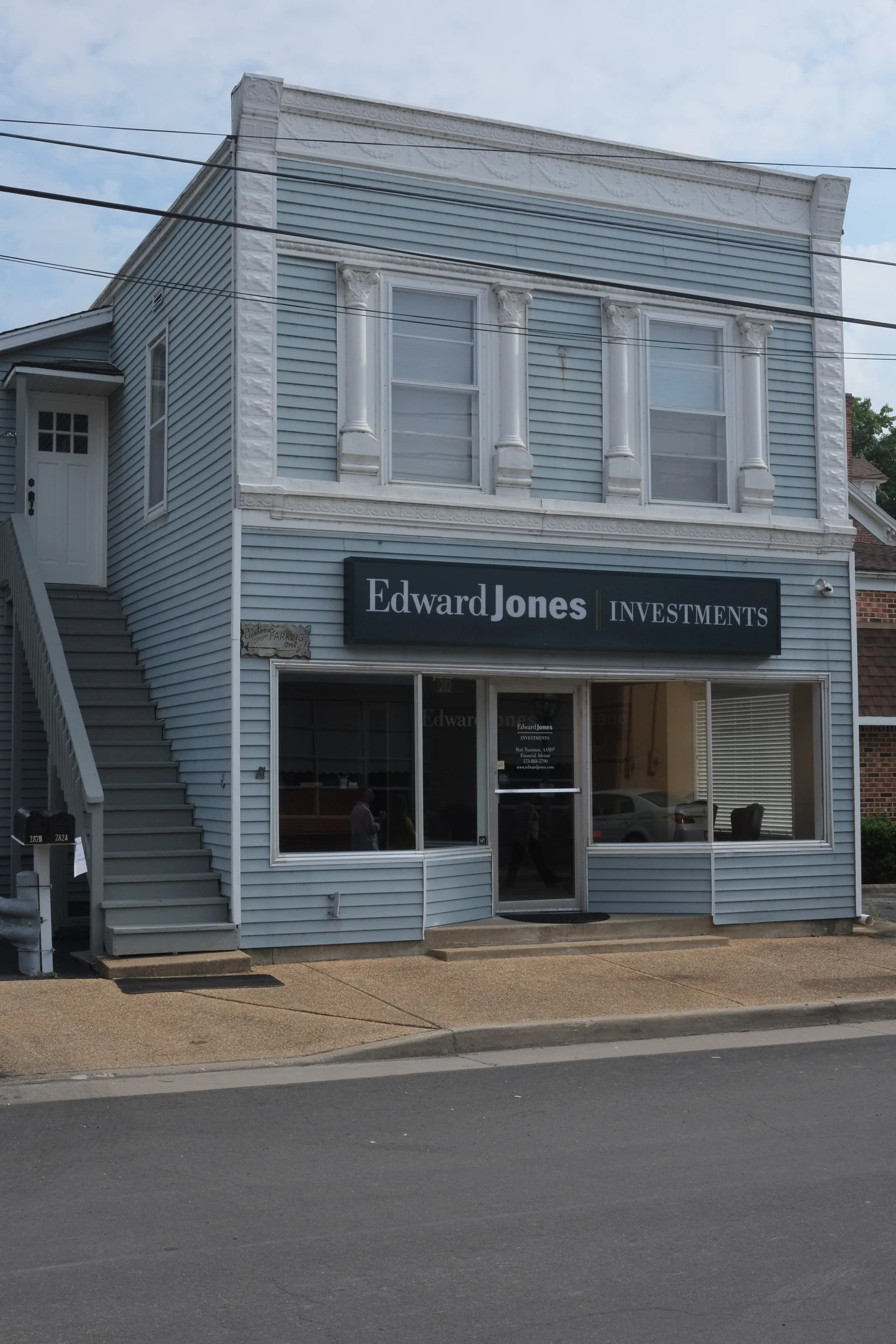 the entrance of a business on the side of a road