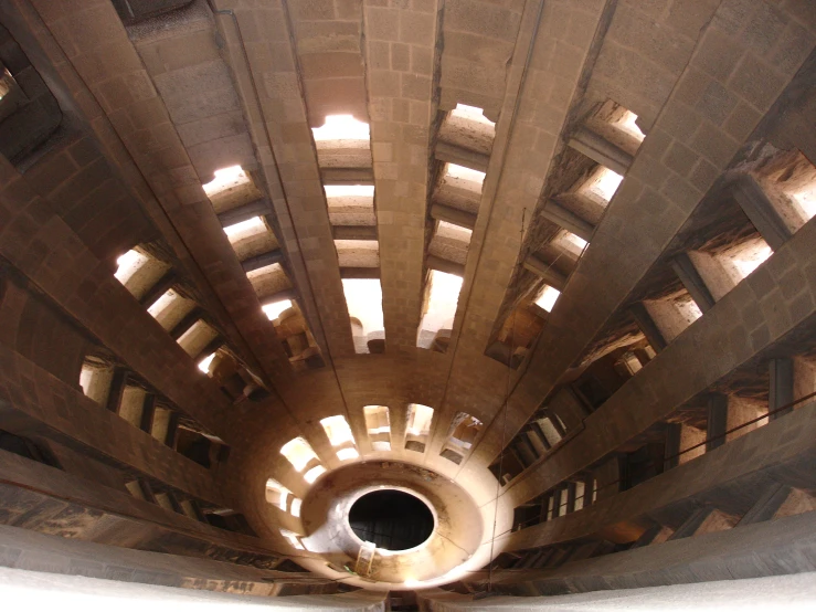 the ceiling inside a building that has a large round window