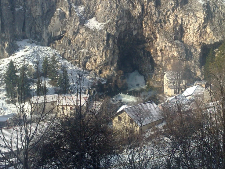 a snowy mountain area with some houses in it