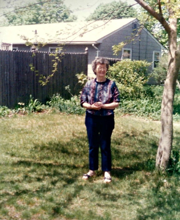 a old picture of a person outside in the grass
