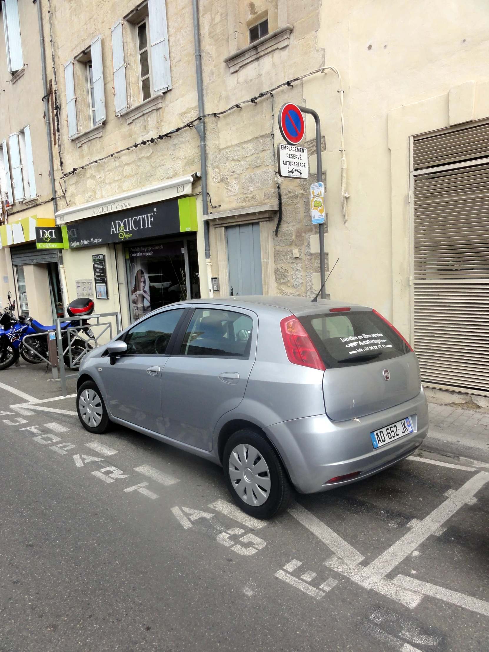 a car parked in front of a street side shop